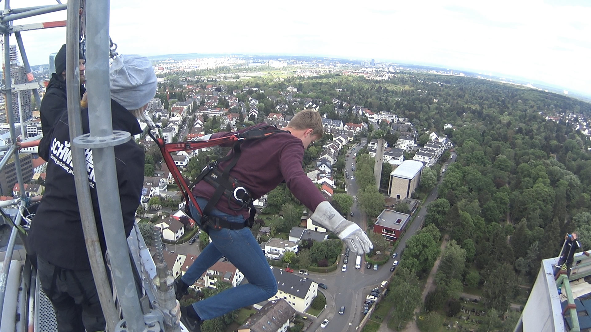 Extreme sports house running - climbing down a skyscraper facade in Frankfurt
