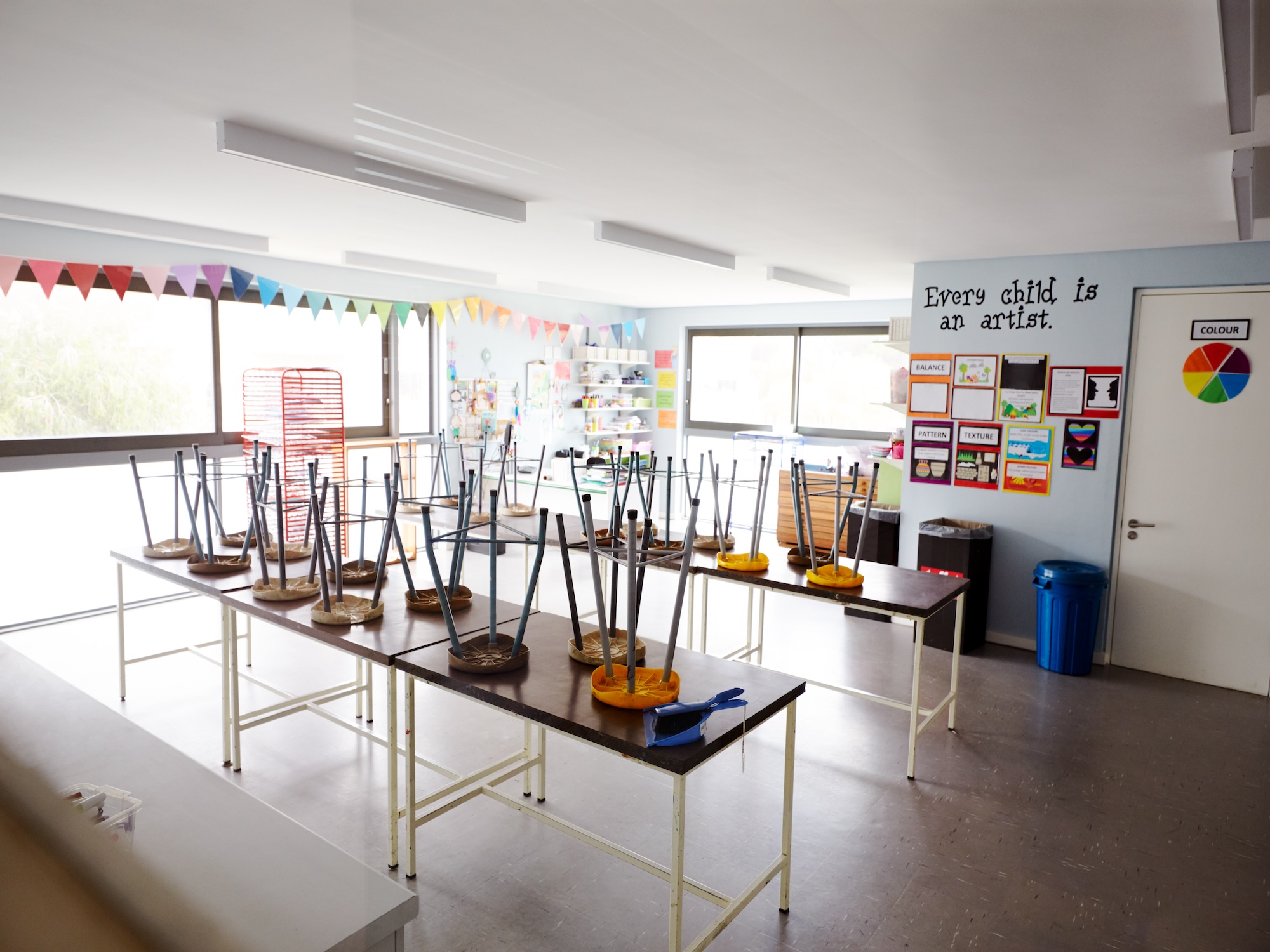 Empty Art Classroom In Elementary School With Chairs Stacked On Tables